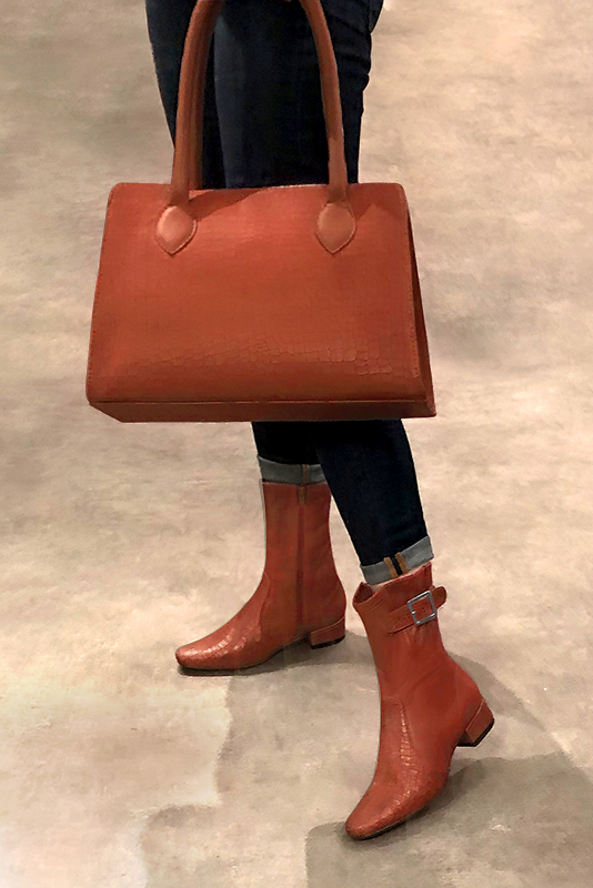 Terracotta orange women's ankle boots with buckles on the sides. Round toe. Low block heels. Worn view - Florence KOOIJMAN